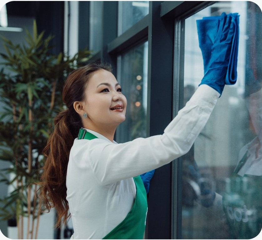top specialist cleaning a workplace window